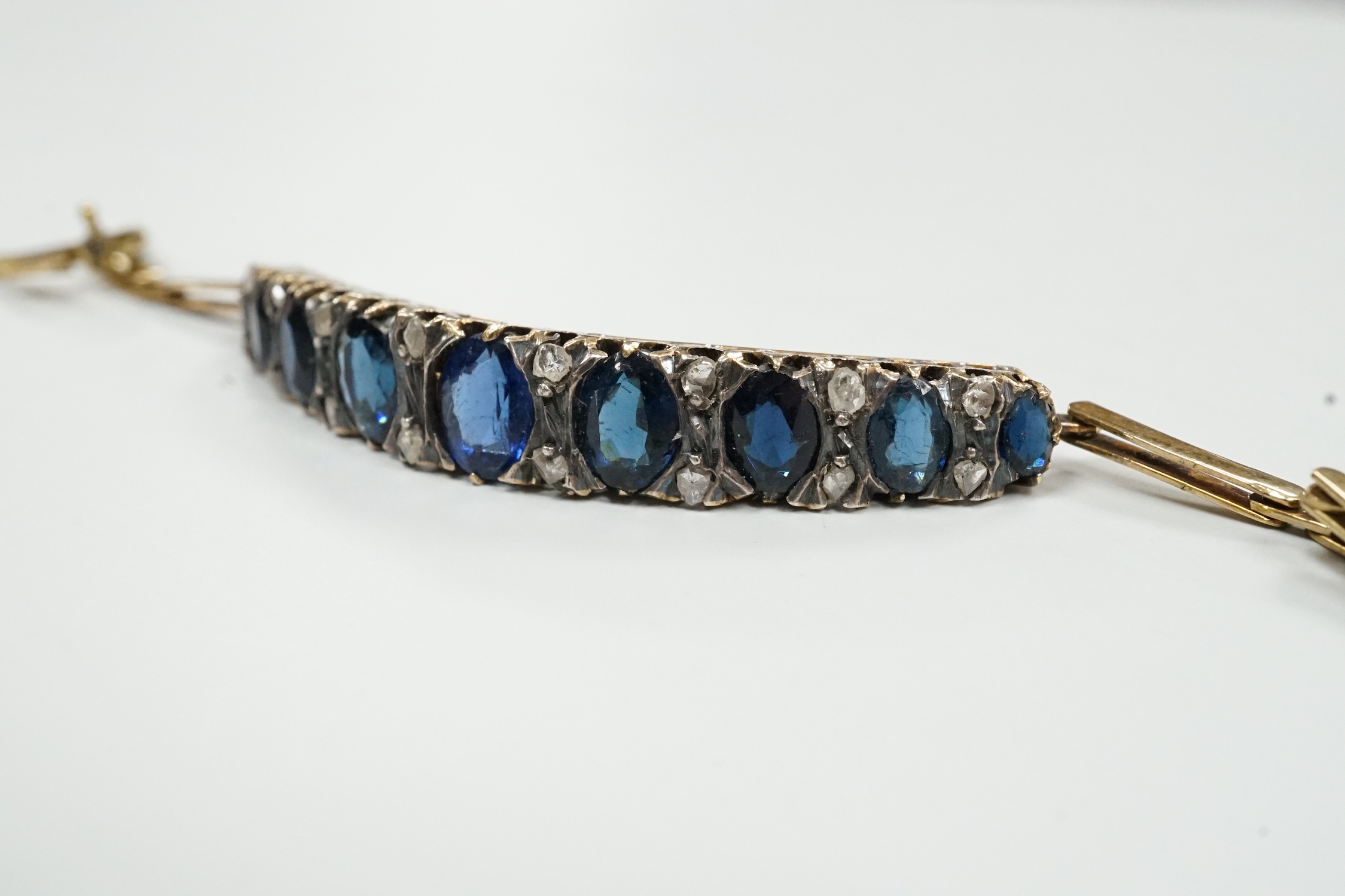 An Edwardian yellow metal, sapphire and rose cut diamond chip set bracelet, approx. 15cm, gross weight 8 grams.